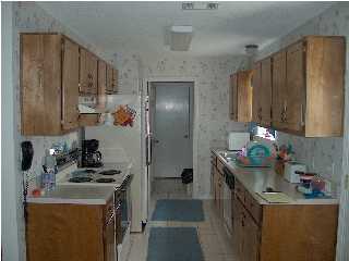 2804 Mac Gregor Lane Crestview, FL 32539 - Photo 2 of 3 a kitchen with a sink stove and refrigerator