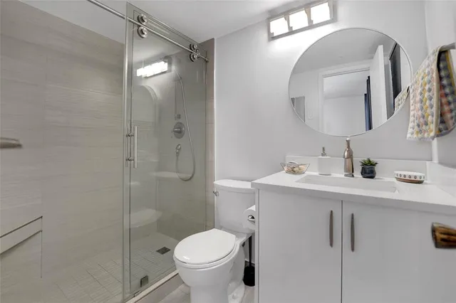 a bathroom with a sink toilet and shower