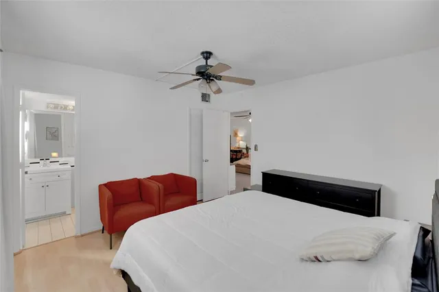 a bedroom with a bed and ceiling fan