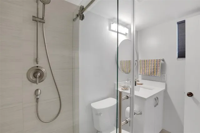 a bathroom with a sink toilet and shower