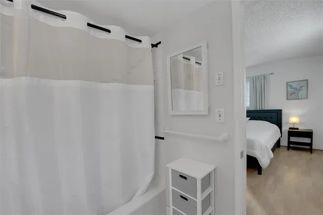 a bed room with a bed and a chair