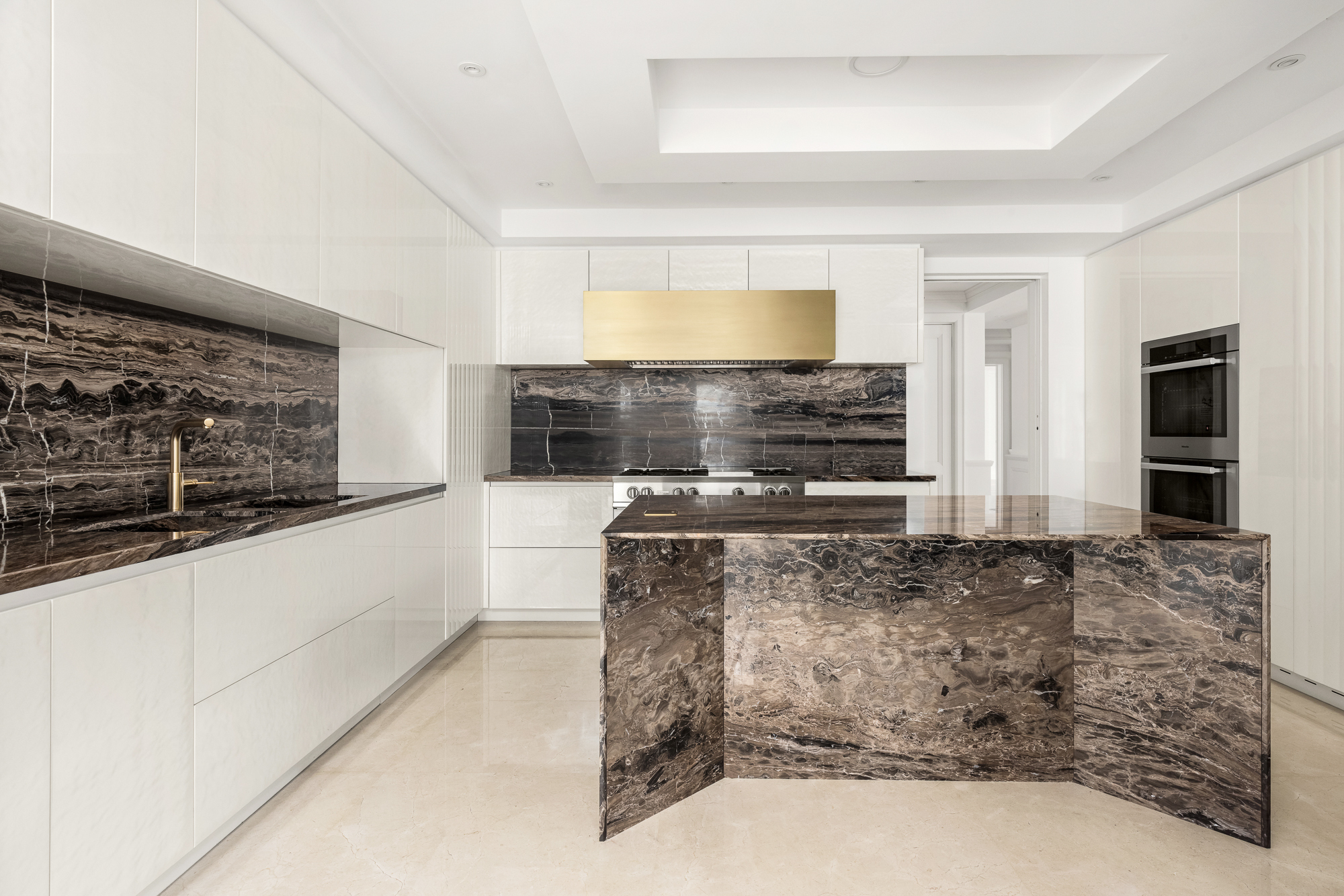 133 East 73rd Street, Unit 3 Manhattan, NY 10021 - Photo 3 of 12 a view of a kitchen with stainless steel appliances kitchen island granite countertop a stove and a sink