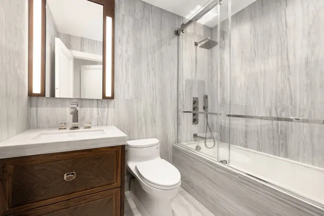 a spacious bedroom with a bed and wooden floor