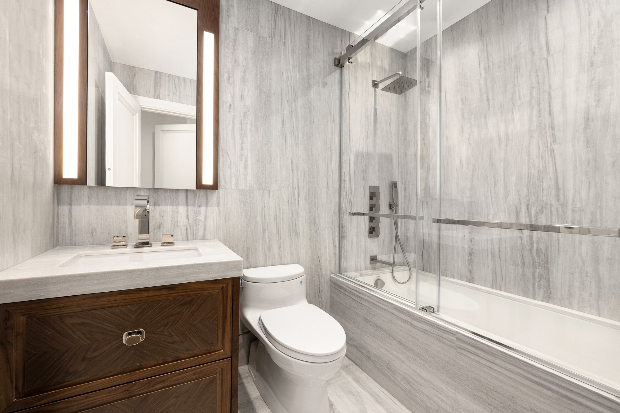 133 East 73rd Street, Unit 3 Manhattan, NY 10021 - Photo 8 of 12 a bathroom with a sink toilet and shower