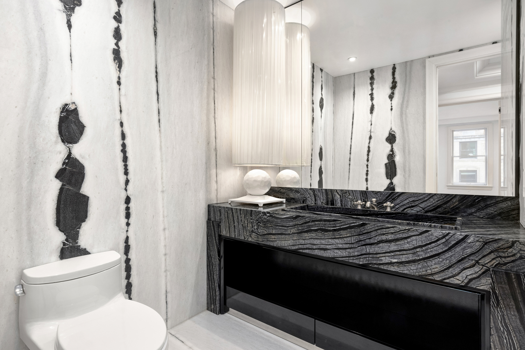 133 East 73rd Street, Unit 3 Manhattan, NY 10021 - Photo 9 of 12 a bathroom with a granite countertop sink a toilet and mirror