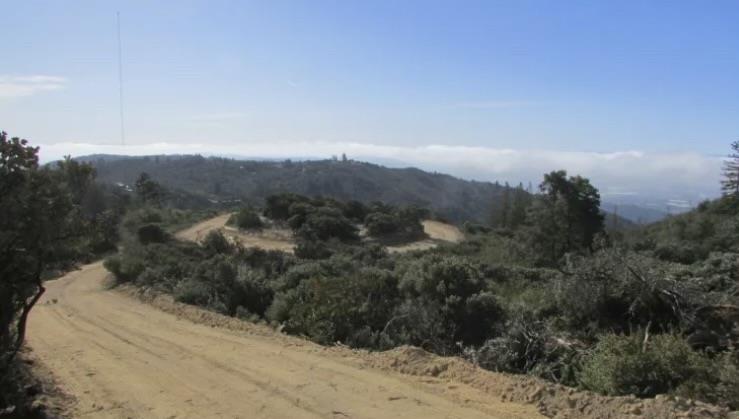 15950 Summit Road Watsonville, CA 95076 - Photo 2 of 27 a view of a dry yard with mountains in the background
