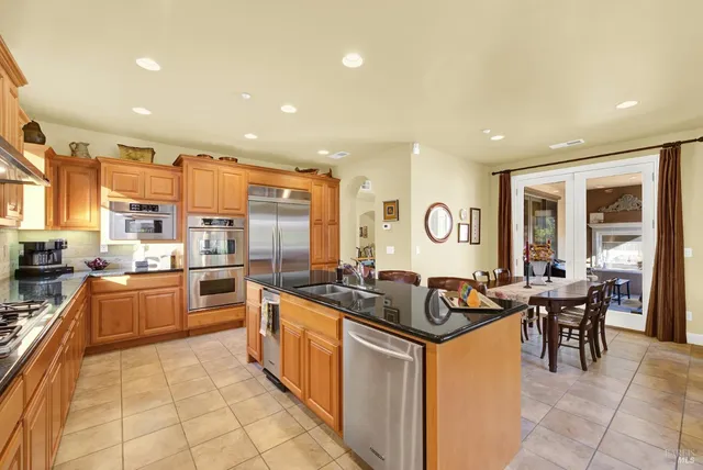 a spacious bedroom with a bed and glass windows