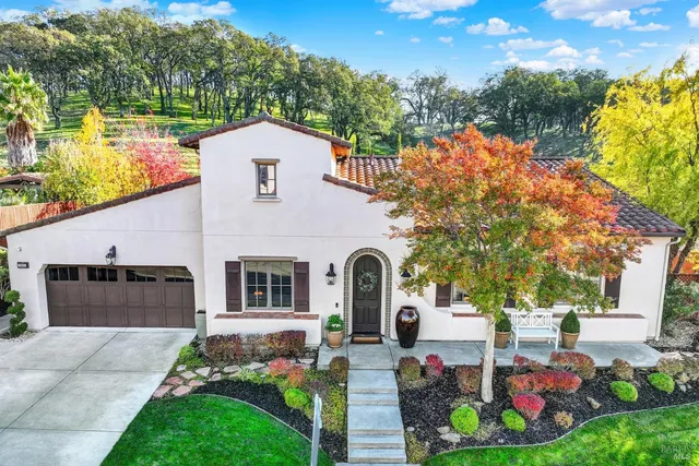 a front view of a house with a yard and garage