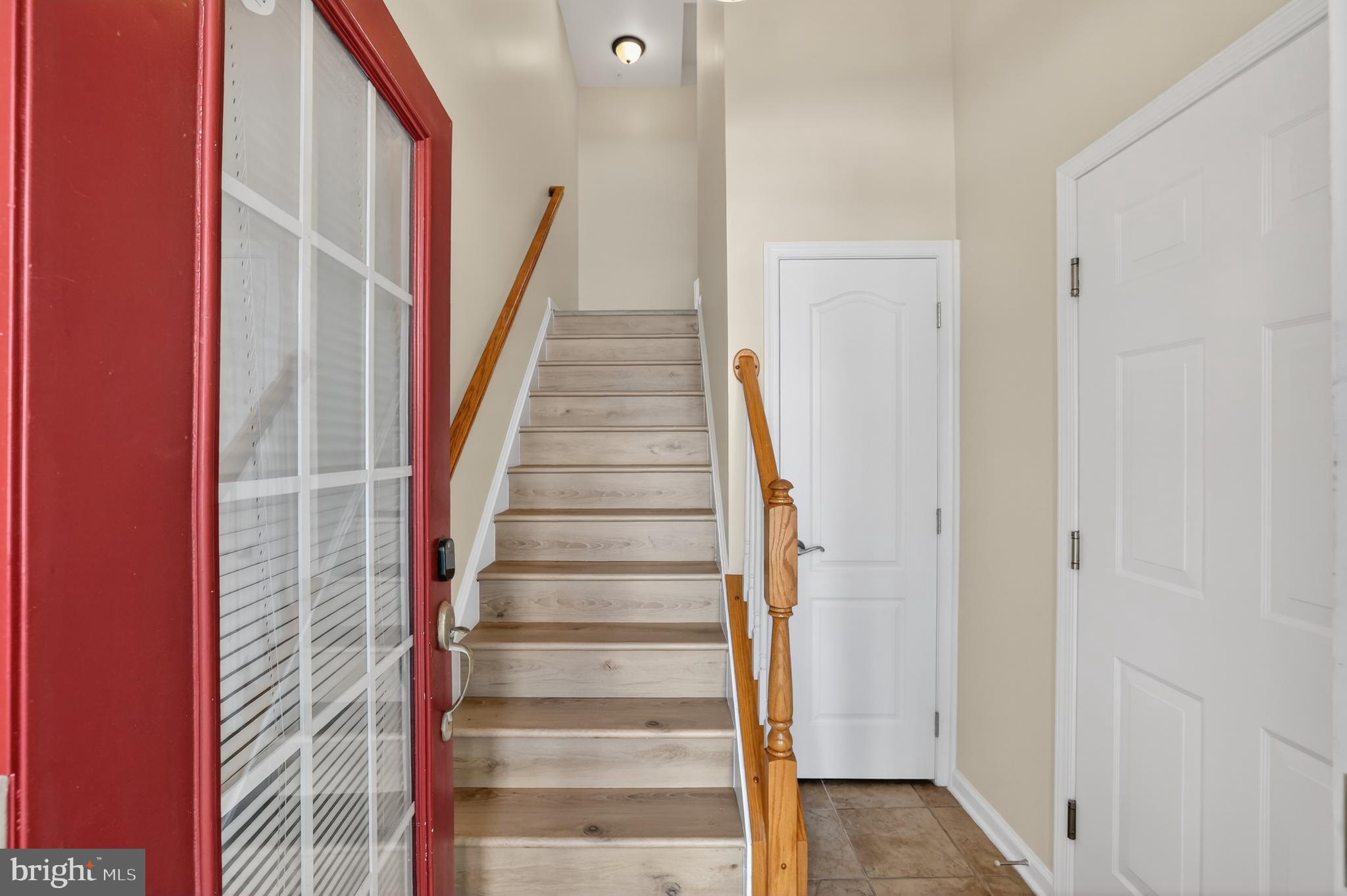 2228 Highfly Terrace, Unit 2228 Silver Spring, MD 20902 - Photo 33 of 35 a view of staircase with white walls and white door