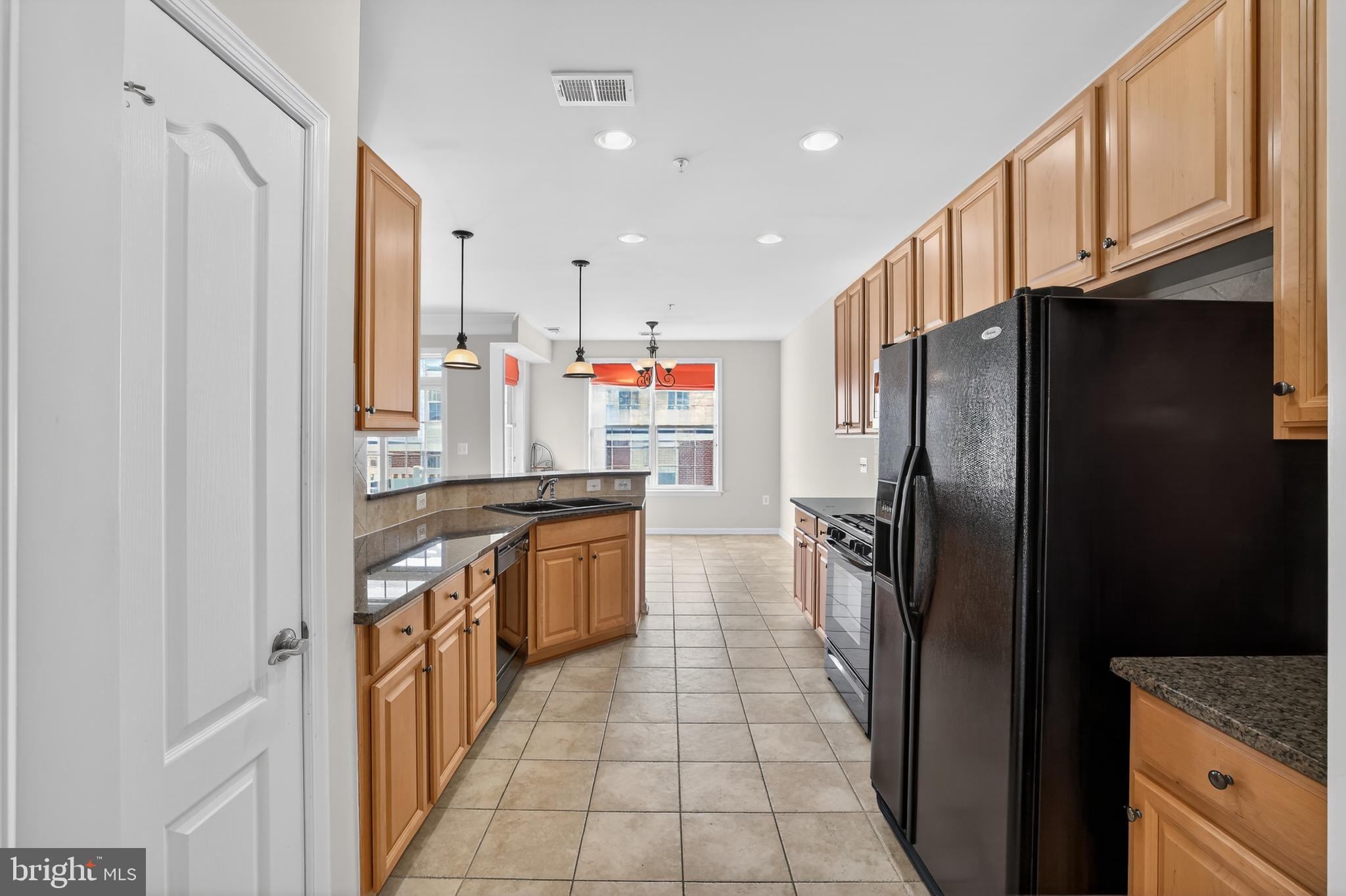 2228 Highfly Terrace, Unit 2228 Silver Spring, MD 20902 - Photo 9 of 35 a kitchen with stainless steel appliances granite countertop a refrigerator and a sink