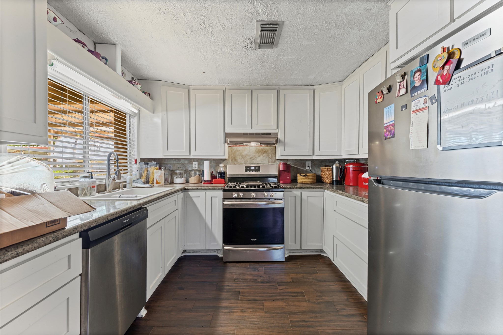 16032 1/2 Ridlon Street Channelview, TX 77530 - Photo 12 of 40 a kitchen with stainless steel appliances granite countertop a stove and a sink