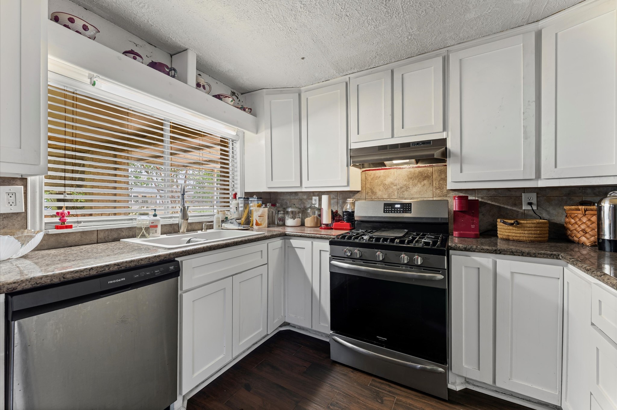 16032 1/2 Ridlon Street Channelview, TX 77530 - Photo 13 of 40 a kitchen with granite countertop white cabinets and white appliances