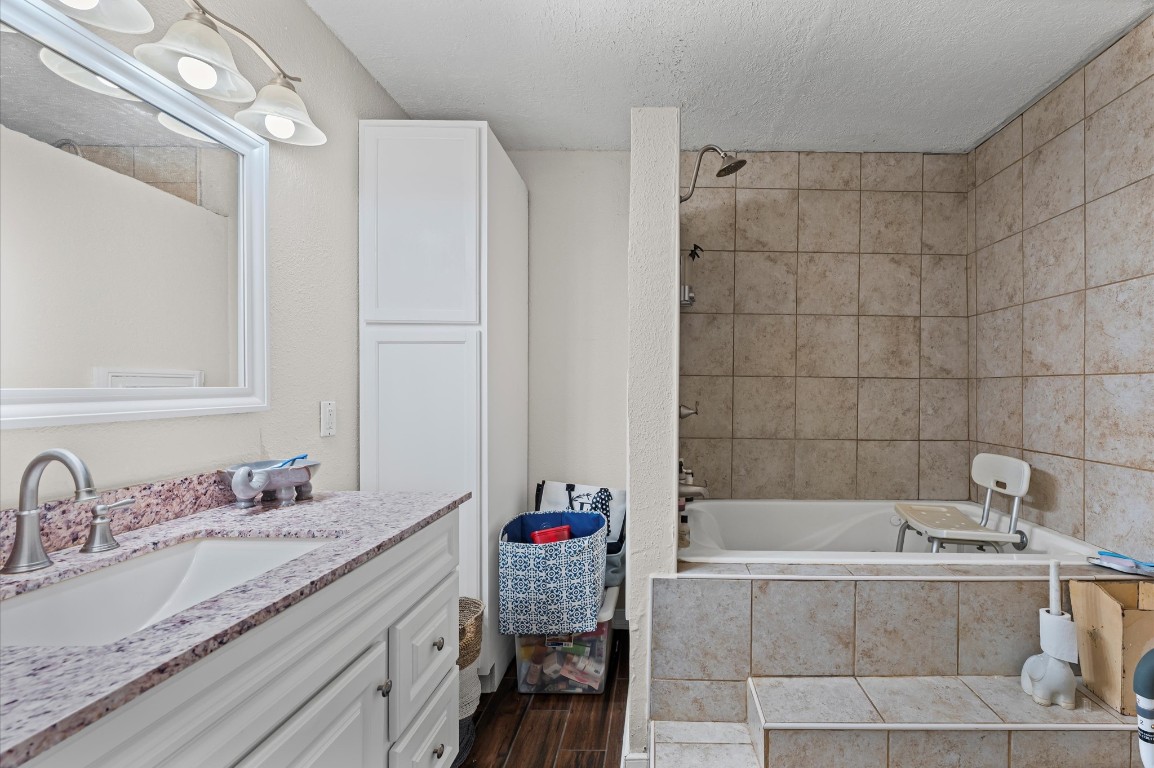 16032 1/2 Ridlon Street Channelview, TX 77530 - Photo 15 of 40 a bathroom with a tub sink and mirror