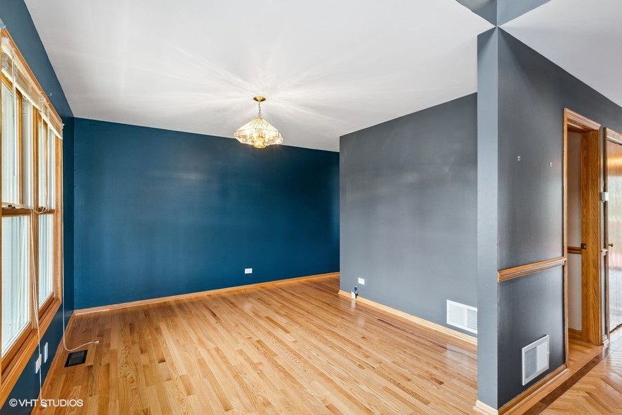 1502 Pine Street Spring Grove, IL 60081 - Photo 4 of 29 a view of a room with wooden floor and a ceiling fan
