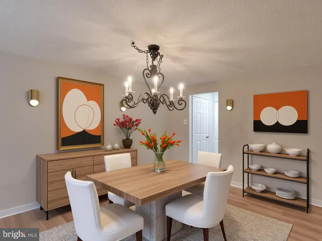 a view of a dining room with furniture and a chandelier