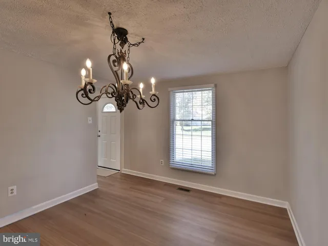 a view of a room with wooden floor