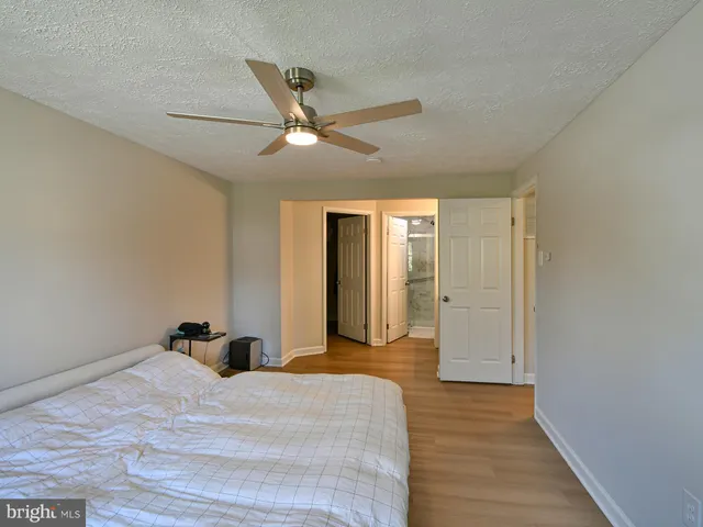 a bedroom with a bed and a ceiling fan