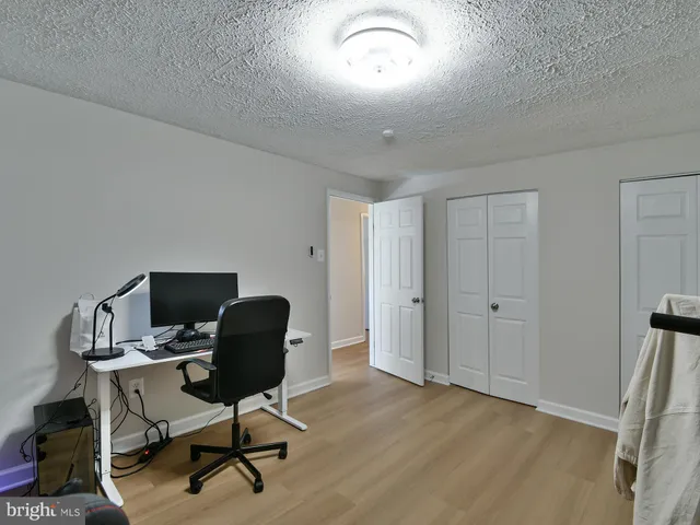 a view of a workspace with furniture and a window