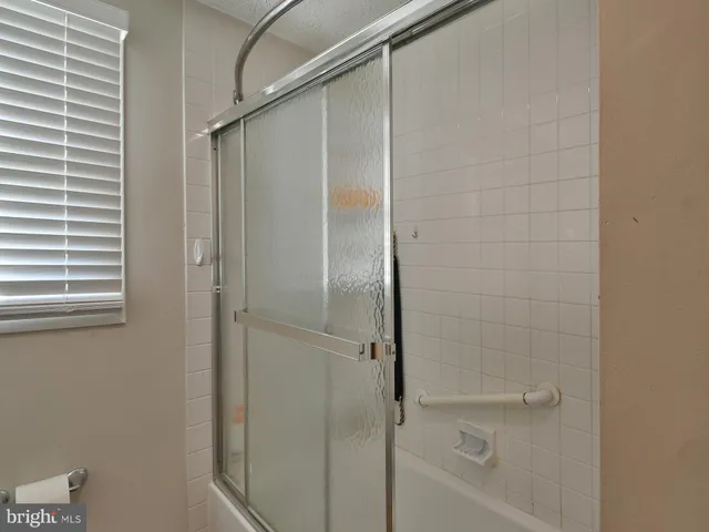 a bathroom with a glass shower door