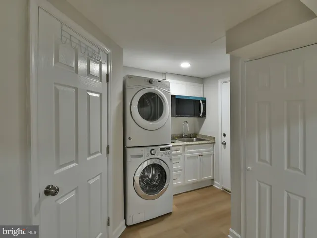 a utility room with sink dryer and washer
