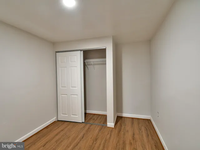 a view of an empty room and wooden floor