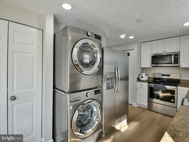 a view of a kitchen with washer and dryer
