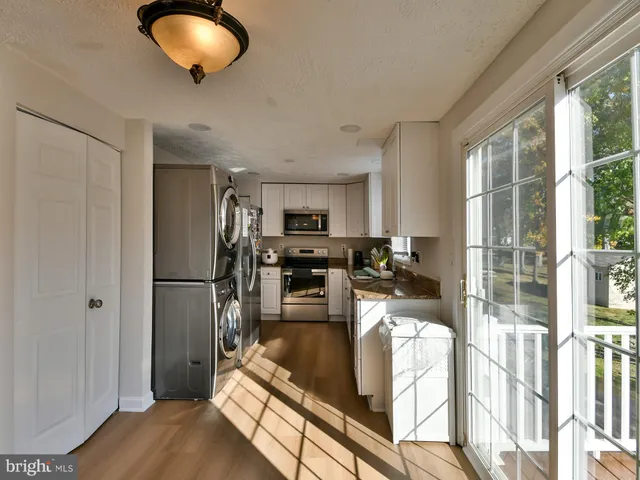 a kitchen with sink refrigerator and microwave