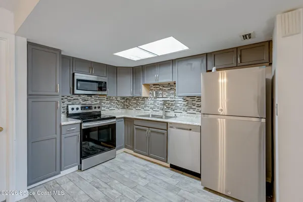 a view of kitchen with sink and wooden floor