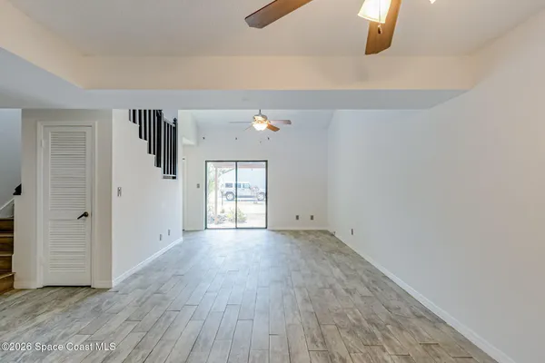 a view of a hallway with wooden floor and entryway