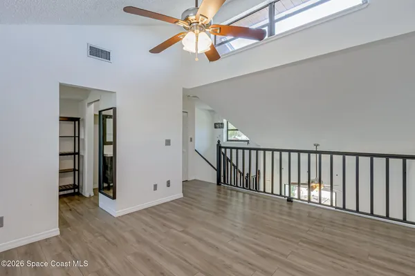 a view of a room with wooden floor