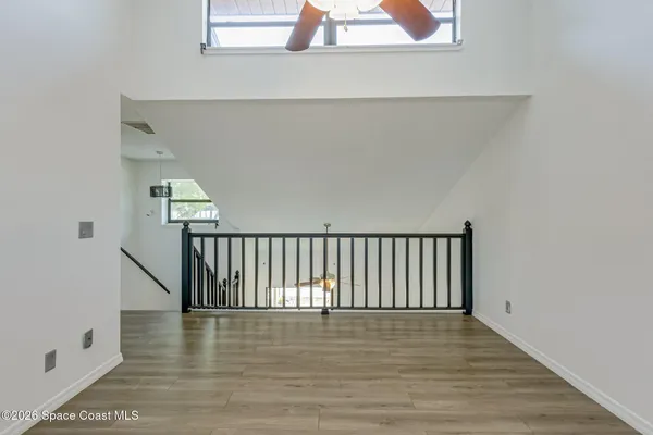 a view of walk in closet with empty racks