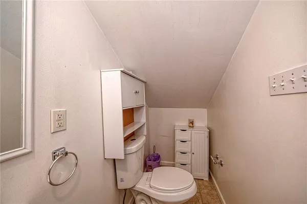 a white toilet sitting next to a bathroom sink