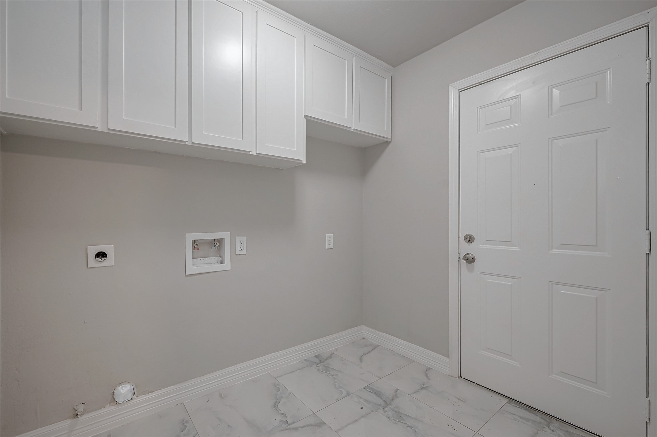 919 Mockingbird Way Sugar Land, TX 77478 - Photo 11 of 41 Laundry room with white cabinets, hook-ups for a washer and dryer.