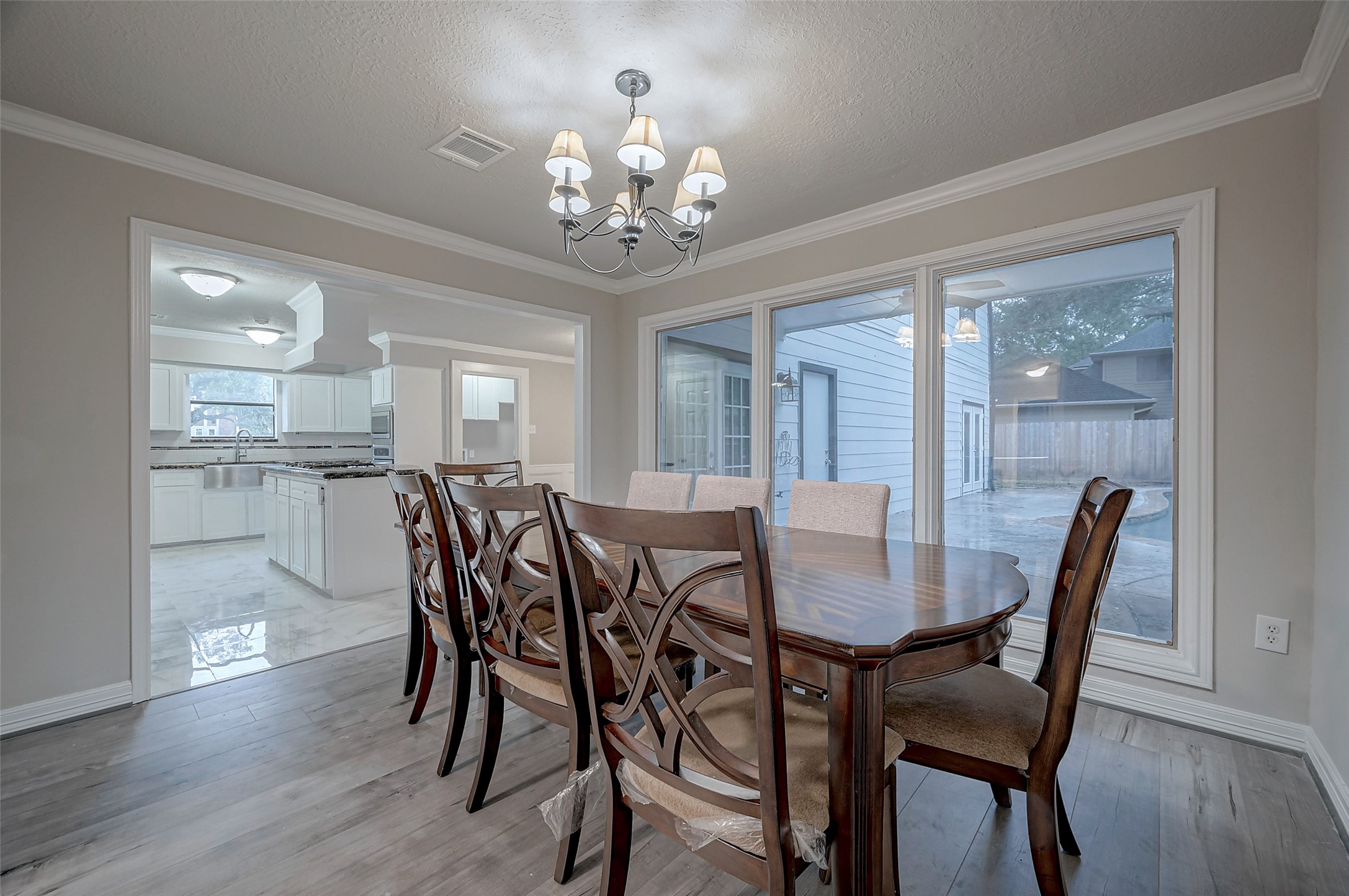 919 Mockingbird Way Sugar Land, TX 77478 - Photo 13 of 41 Large windows offering a stunning view and a classic wooden dining table.