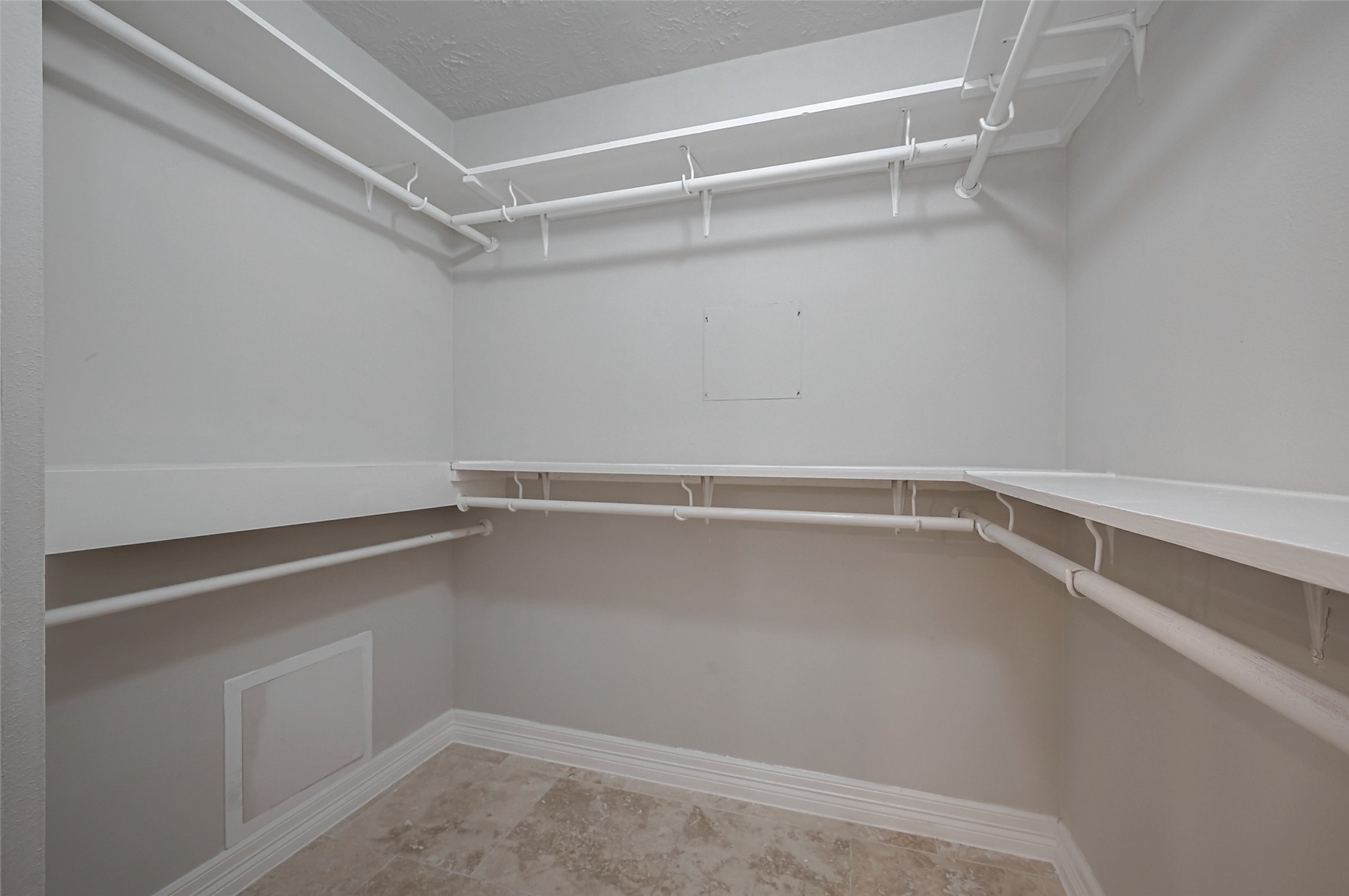 919 Mockingbird Way Sugar Land, TX 77478 - Photo 20 of 41 Spacious walk-in closet with multiple white shelves and hanging rods.