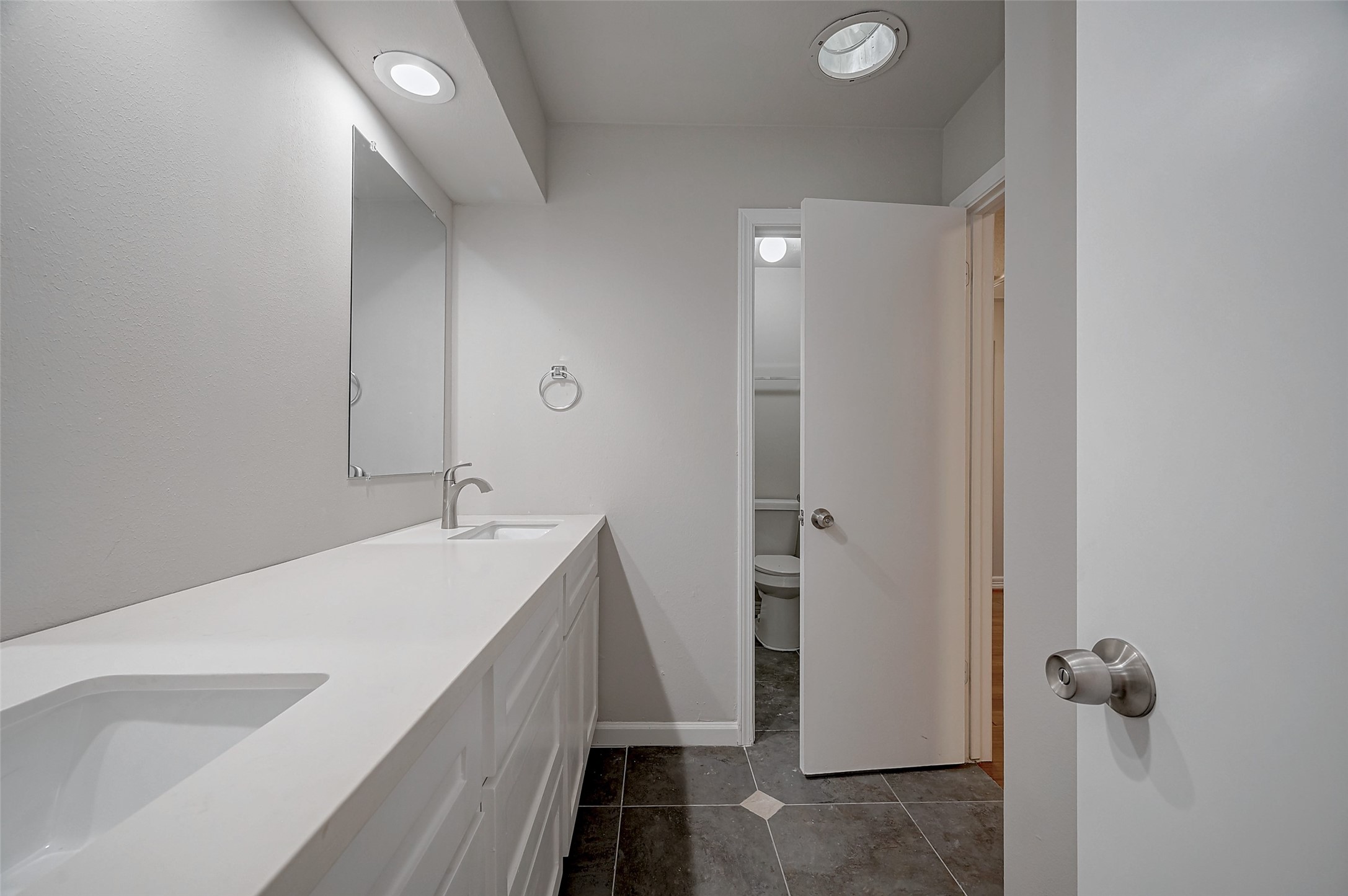 919 Mockingbird Way Sugar Land, TX 77478 - Photo 28 of 41 Bathroom, featuring a double vanity and sleek white countertops.
