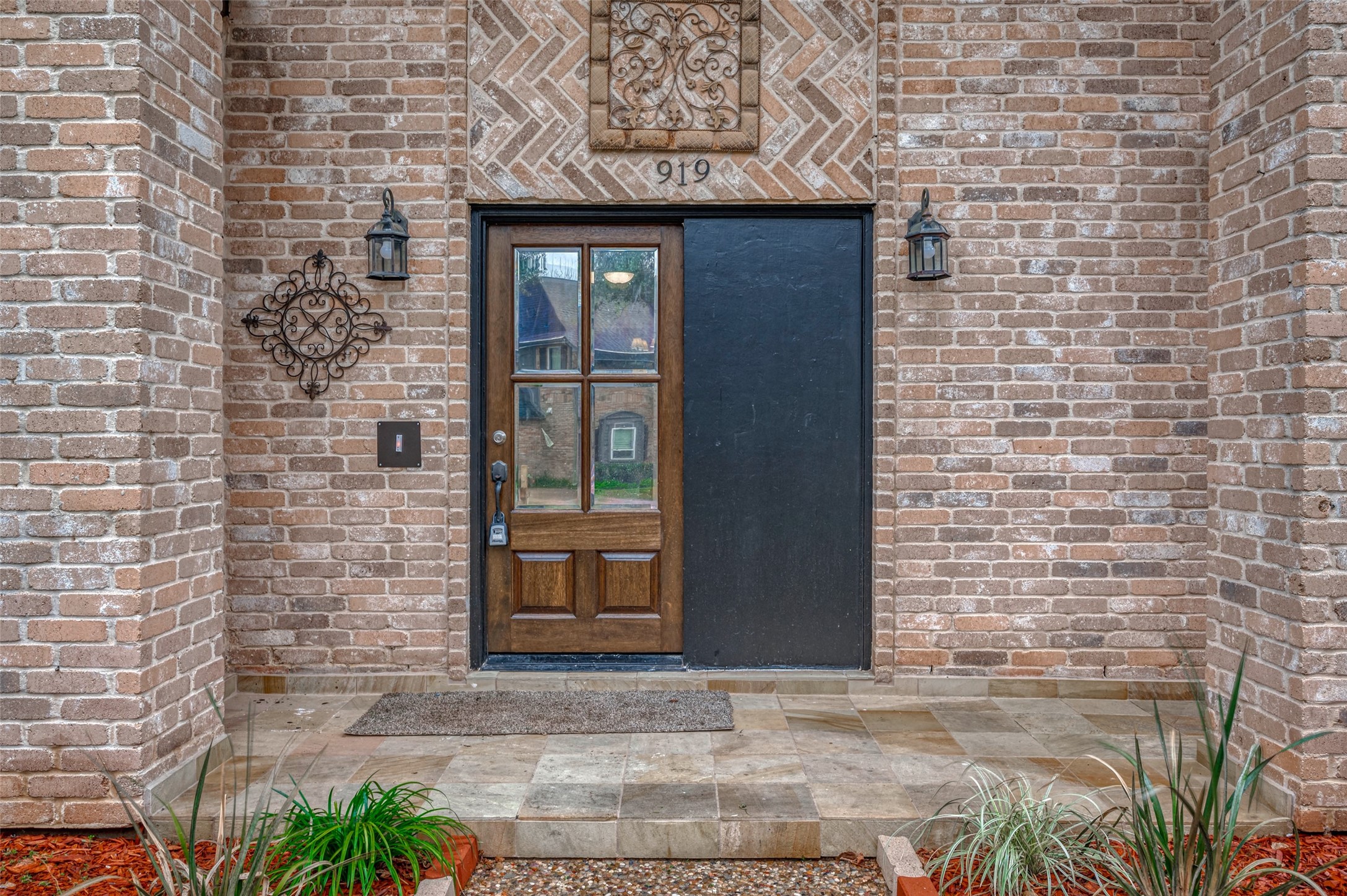919 Mockingbird Way Sugar Land, TX 77478 - Photo 2 of 41 Welcoming brick entrance with a wooden door featuring glass panels.