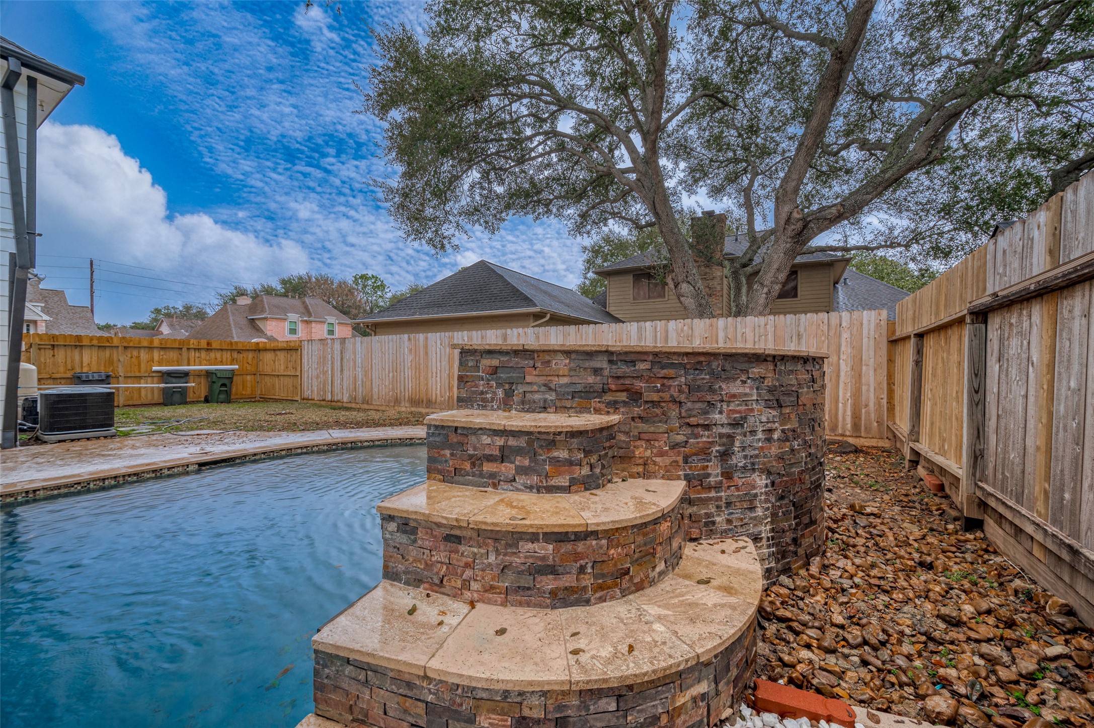 919 Mockingbird Way Sugar Land, TX 77478 - Photo 40 of 41 A three-tiered stone waterfall enhances the pool serenity.