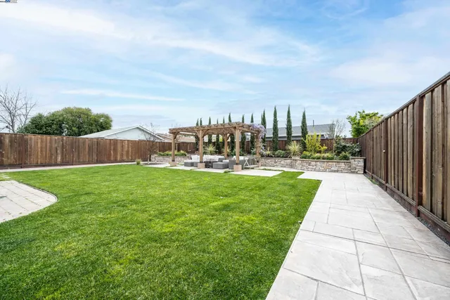 a view of yard with swimming pool and seating