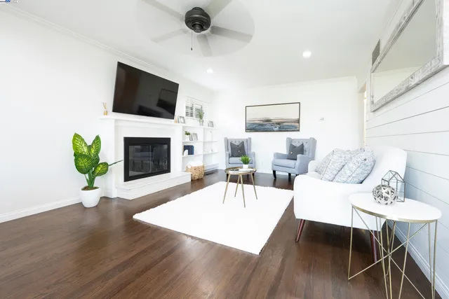 a living room with furniture a fireplace and a flat screen tv