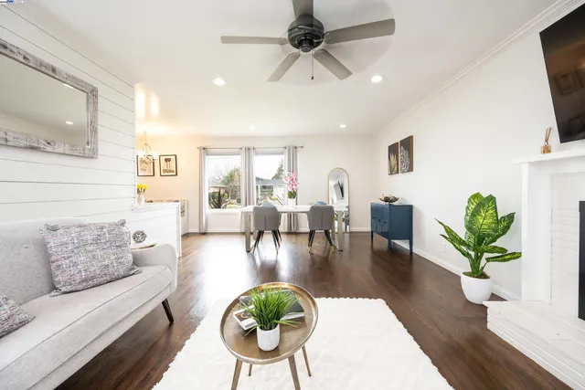a living room with fireplace furniture and a wooden floor