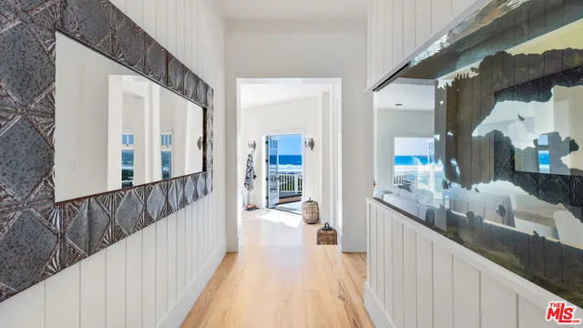 a living room with furniture a large window and a fireplace