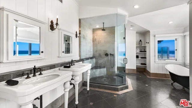 a bedroom with a white bed and a flat screen tv