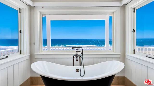 a bedroom with a bed and a large mirror on the wall