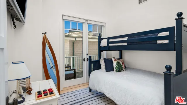 a bedroom with a bed and a painting on the wall