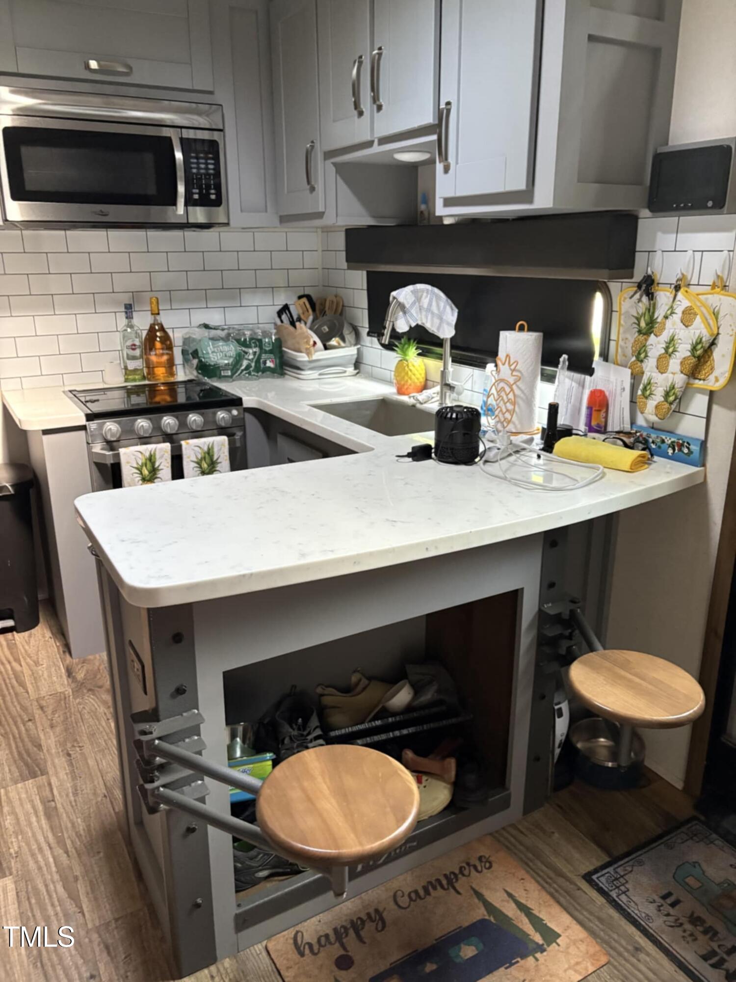 147 Osage Drive Spring Hope, NC 27882 - Photo 11 of 14 a kitchen with a sink a stove and cabinets
