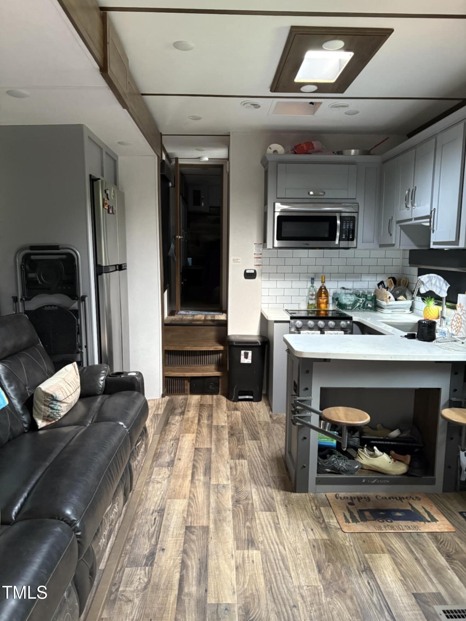 147 Osage Drive Spring Hope, NC 27882 - Photo 6 of 14 a kitchen with stainless steel appliances wooden floor and a refrigerator