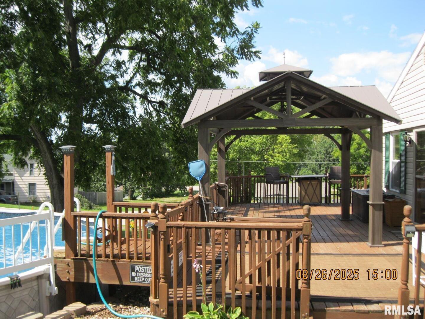 301 North Church Street Albany, IL 61230 - Photo 20 of 22 a view of a wooden deck with chairs and large trees