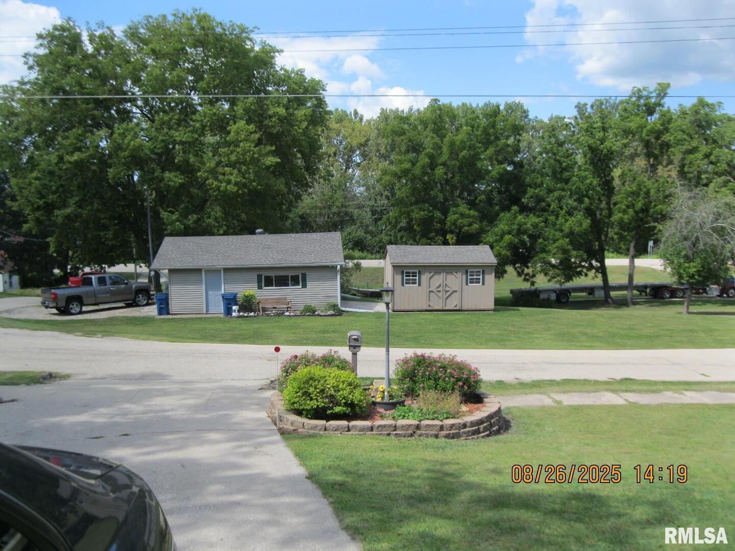 301 North Church Street Albany, IL 61230 - Photo 2 of 22 a front view of a house with garden