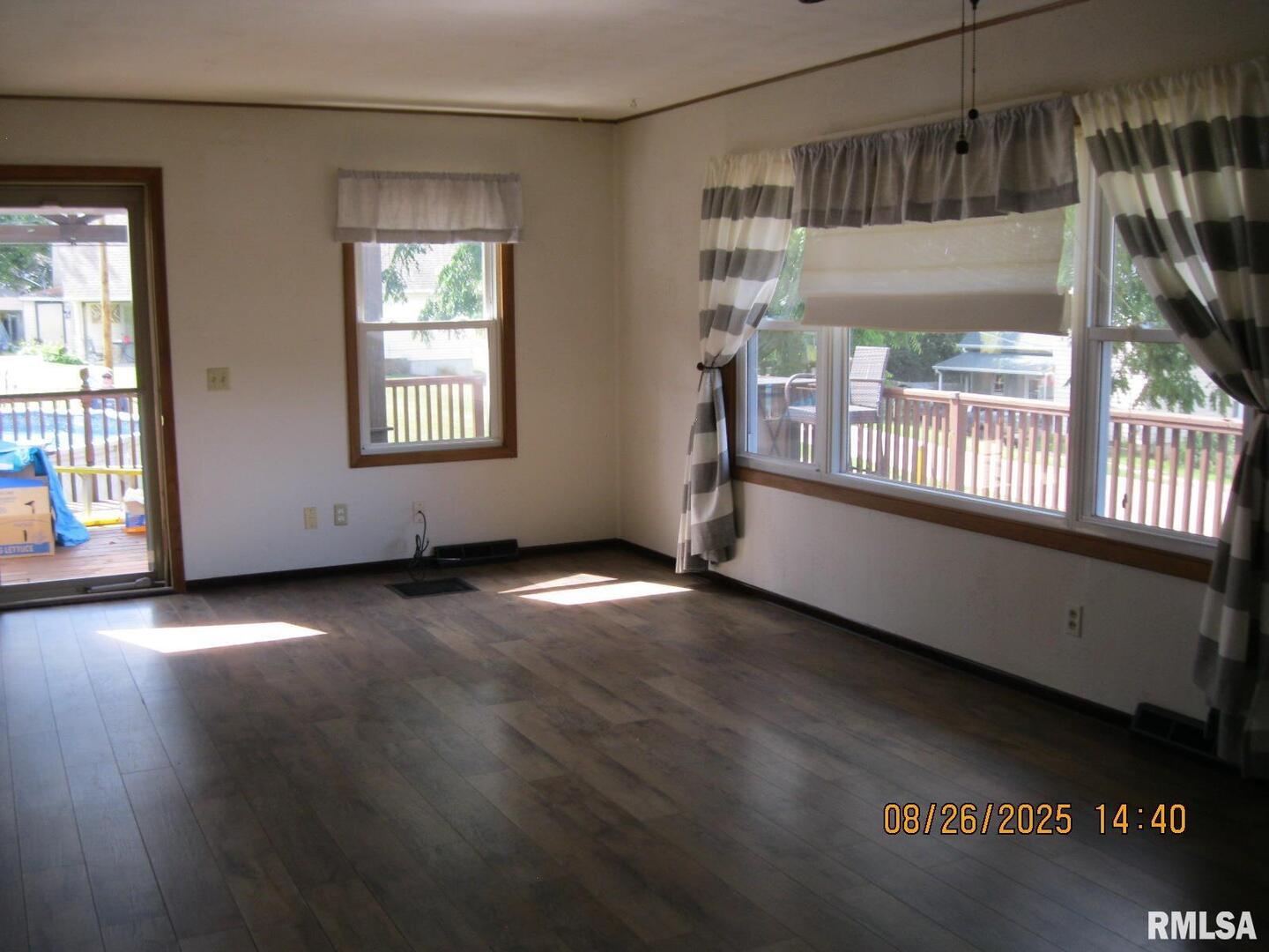 301 North Church Street Albany, IL 61230 - Photo 3 of 22 an empty room with wooden floor and windows